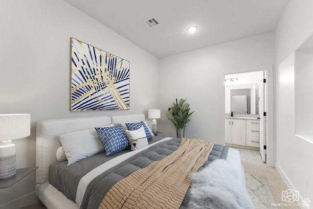 665 E 2015 N # 5E, Cedar City, UT 84721 - bedroom featuring light colored carpet, visible vents, baseboards, and ensuite bathroom