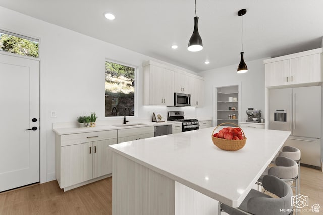 665 E 2015 N # 5E, Cedar City, UT 84721 - kitchen with light wood-type flooring, a breakfast bar area, stainless steel appliances, and a sink
