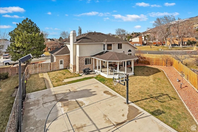 1434 Bennett Cir, Farmington, UT 84025 - back of property featuring a fenced backyard, a chimney, a lawn, and a patio