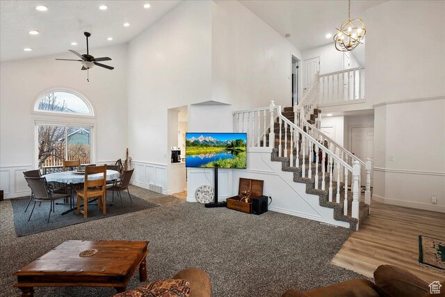 1434 Bennett Cir, Farmington, UT 84025 - living area with a wainscoted wall, stairs, high vaulted ceiling, and a decorative wall