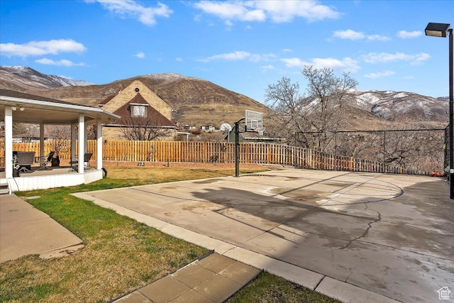 1434 Bennett Cir, Farmington, UT 84025 - view of patio / terrace with a mountain view, basketball hoop, and fence