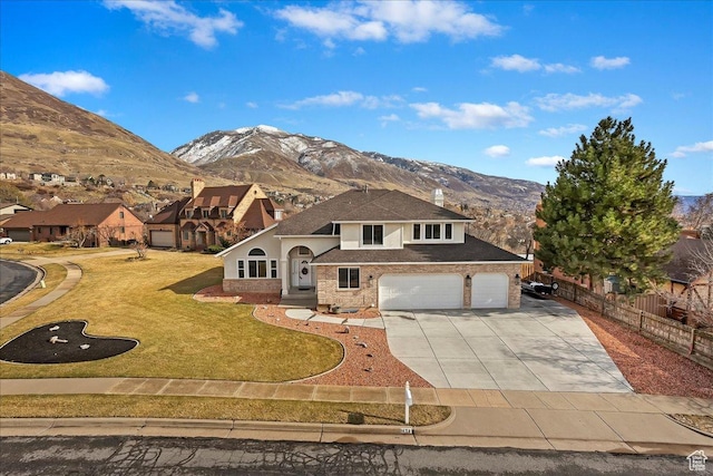 1434 Bennett Cir, Farmington, UT 84025 - view of front of home featuring brick siding, a front yard, a mountain view, fence, and driveway