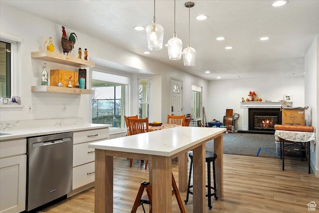 1434 Bennett Cir, Farmington, UT 84025 - kitchen featuring light wood finished floors, recessed lighting, dishwasher, and a glass covered fireplace
