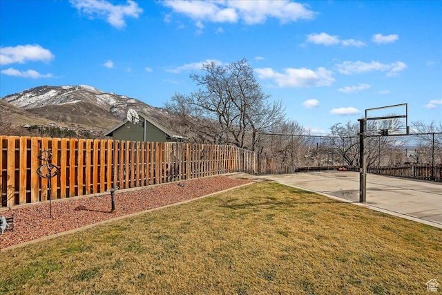 1434 Bennett Cir, Farmington, UT 84025 - view of yard with fence, a mountain view, and basketball court