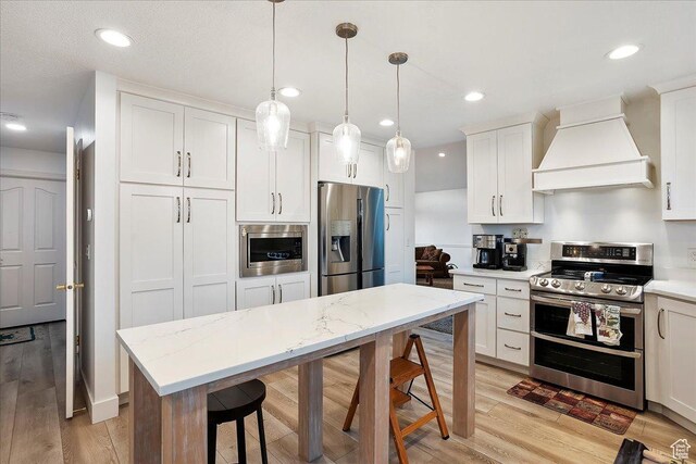1434 Bennett Cir, Farmington, UT 84025 - kitchen with appliances with stainless steel finishes, light wood-type flooring, premium range hood, and white cabinetry