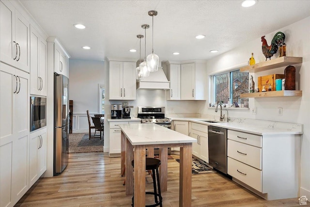 1434 Bennett Cir, Farmington, UT 84025 - kitchen with hanging light fixtures, appliances with stainless steel finishes, light wood-type flooring, and a sink