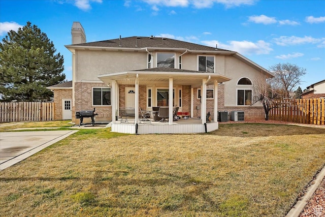 1434 Bennett Cir, Farmington, UT 84025 - back of property with a yard, fence, stucco siding, and brick siding