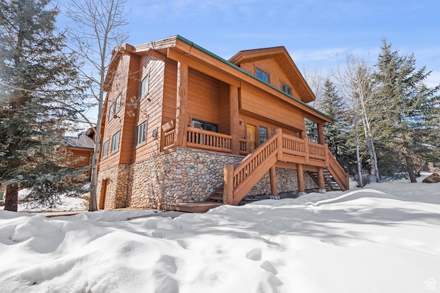 3995 N Timberwolf Ln Unit 1A, Park City, UT 84098 - view of snowy exterior with stone siding and stairway