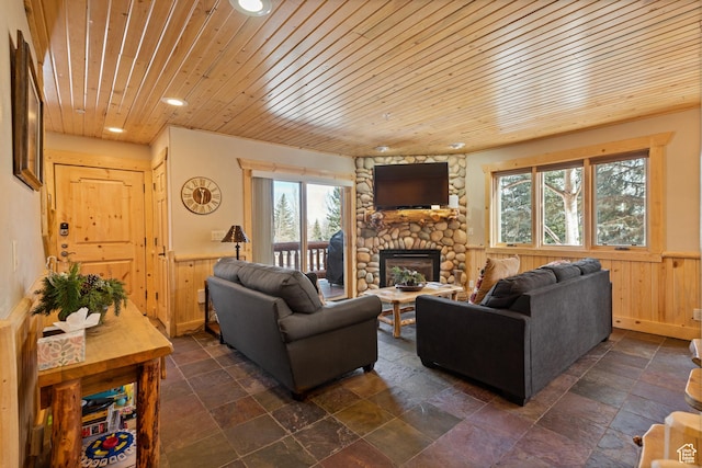 3995 N Timberwolf Ln Unit 1A, Park City, UT 84098 - living room featuring wainscoting, a stone fireplace, wooden ceiling, and wooden walls