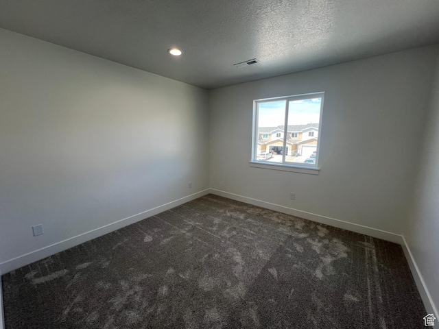 14 E 300 S, Delta, UT 84624 - empty room with dark colored carpet, visible vents, and baseboards
