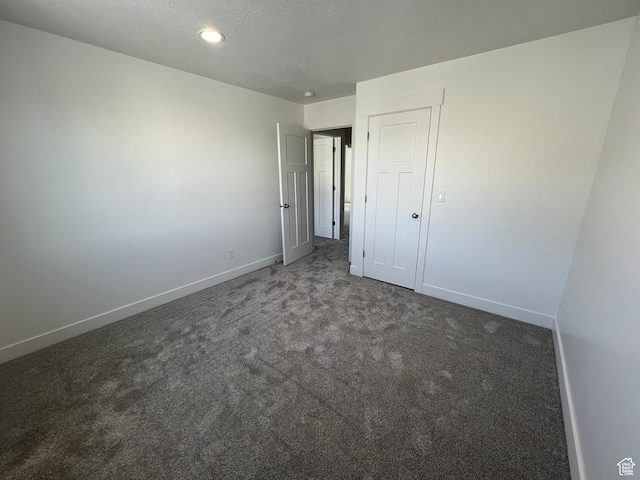 14 E 300 S, Delta, UT 84624 - unfurnished bedroom featuring a textured ceiling, baseboards, and carpet flooring