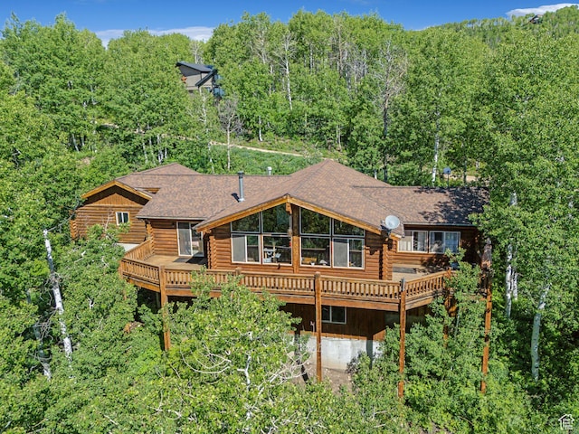1973 W Modoc Loop, Coalville, UT 84017 - rear view of property with log exterior, a deck, roof with shingles, and a forest view