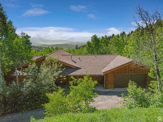 1973 W Modoc Loop, Coalville, UT 84017 - view of front of property featuring a mountain view, roof with shingles, and a garage