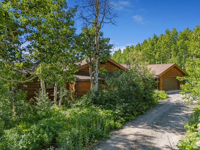 1973 W Modoc Loop, Coalville, UT 84017 - view of front of home with a garage, a shingled roof, and driveway