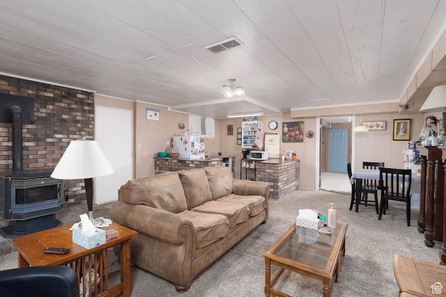 86 E 1000 S, Panguitch, UT 84759 - carpeted living area with a wood stove, wooden ceiling, and visible vents