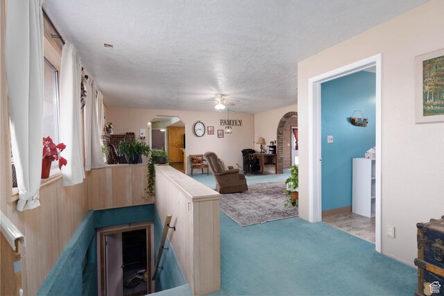 86 E 1000 S, Panguitch, UT 84759 - interior space featuring arched walkways, a textured ceiling, and carpet