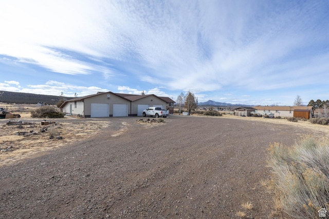 86 E 1000 S, Panguitch, UT 84759 - single story home featuring dirt driveway, an outbuilding, and a garage