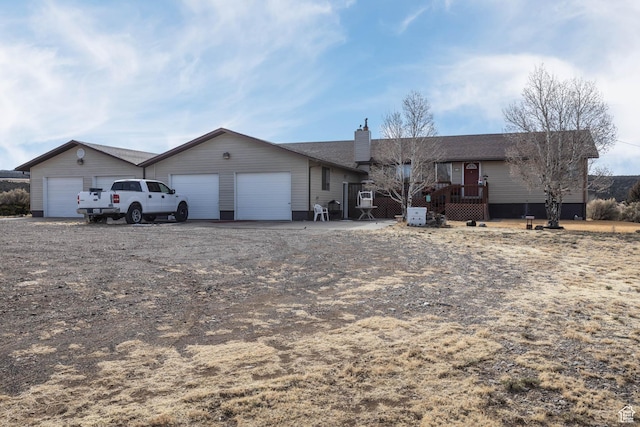 86 E 1000 S, Panguitch, UT 84759 - single story home with driveway, a garage, a chimney, a deck, and an outdoor structure