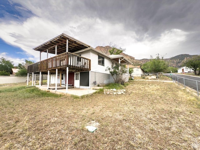 138 W 100 N, East Carbon, UT 84520 - back of property featuring a deck with mountain view and a patio area