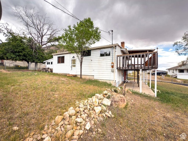 138 W 100 N, East Carbon, UT 84520 - back of house featuring a deck, a chimney, and a patio