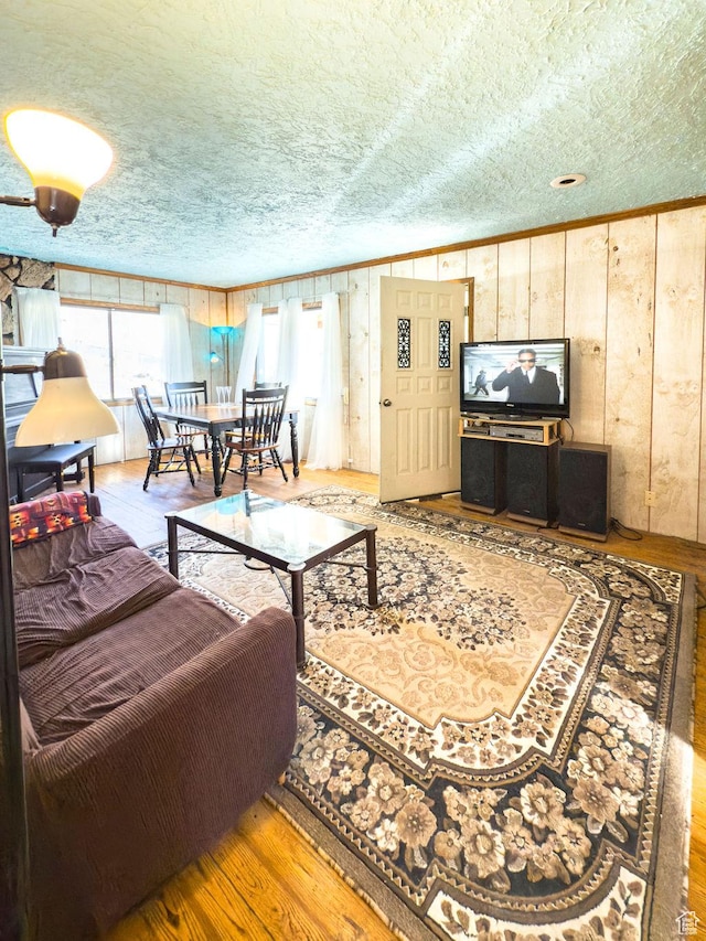 138 W 100 N, East Carbon, UT 84520 - living room featuring crown molding, wooden walls, wood finished floors, and a textured ceiling