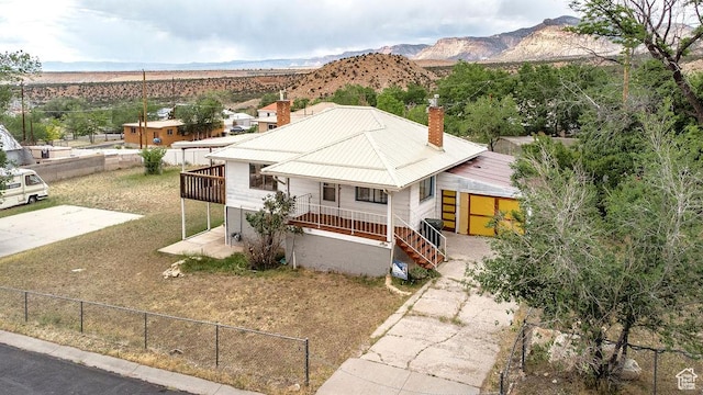 138 W 100 N, East Carbon, UT 84520 - view of front of property with a chimney, a mountain view, and a metal roof
