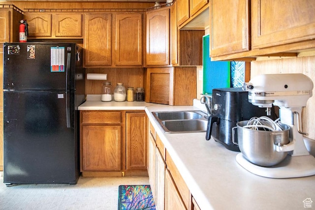 138 W 100 N, East Carbon, UT 84520 - kitchen featuring brown cabinets, light countertops, freestanding refrigerator, and a sink