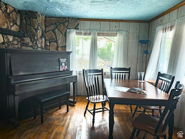 138 W 100 N, East Carbon, UT 84520 - dining area featuring wood-type flooring, wood walls, and a textured ceiling