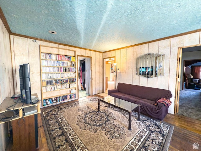 138 W 100 N, East Carbon, UT 84520 - living room with ornamental molding, a textured ceiling, wood finished floors, wood walls, and vaulted ceiling