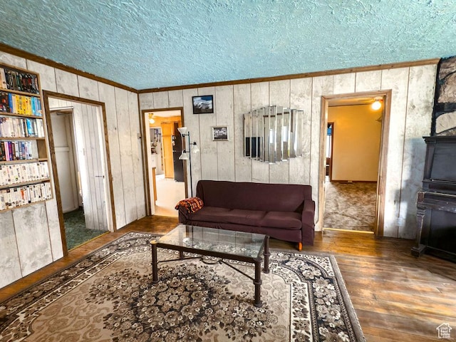 138 W 100 N, East Carbon, UT 84520 - living area featuring crown molding, hardwood / wood-style flooring, a textured ceiling, and wooden walls