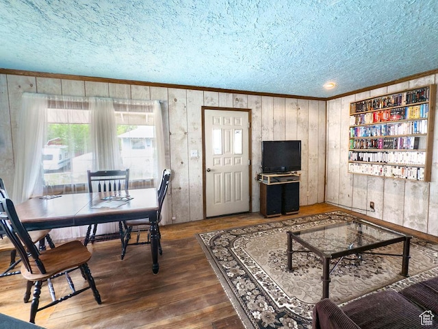 138 W 100 N, East Carbon, UT 84520 - living area with a textured ceiling, crown molding, wood-type flooring, and wooden walls
