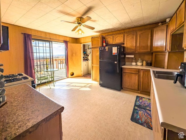 138 W 100 N, East Carbon, UT 84520 - kitchen with brown cabinetry, a ceiling fan, freestanding refrigerator, and a sink
