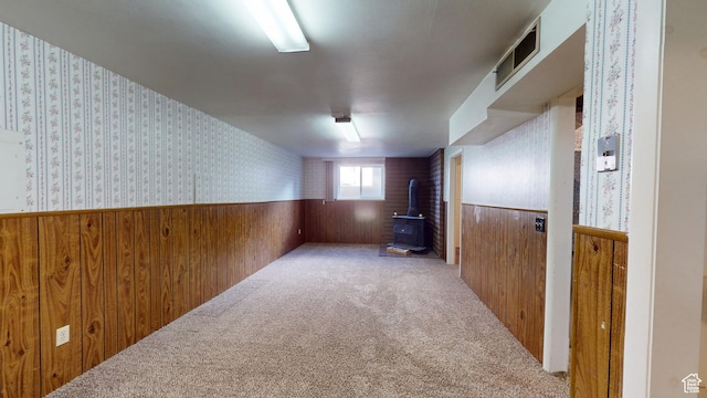 1120 Bulloch Cir, Cedar City, UT 84721 - interior space with wooden walls, visible vents, wainscoting, a wood stove, and wallpapered walls