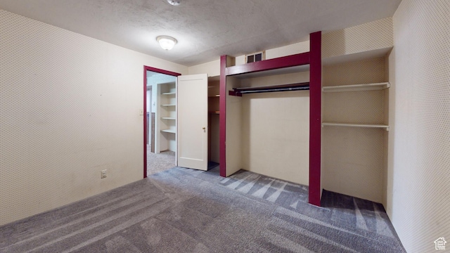 1120 Bulloch Cir, Cedar City, UT 84721 - unfurnished bedroom featuring wallpapered walls, visible vents, carpet, a textured ceiling, and a closet