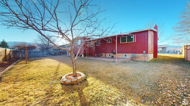 1120 Bulloch Cir, Cedar City, UT 84721 - rear view of house featuring entry steps, fence private yard, a chimney, and a lawn