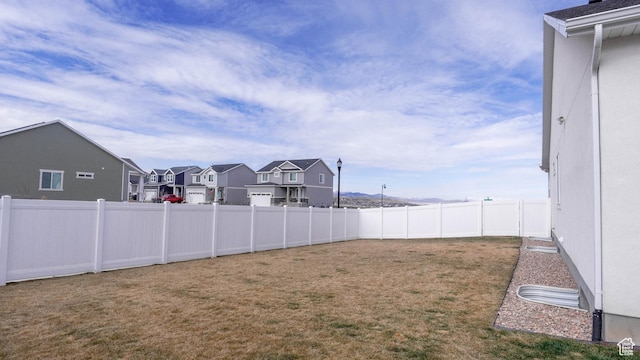view of yard with a residential view and a fenced backyard
