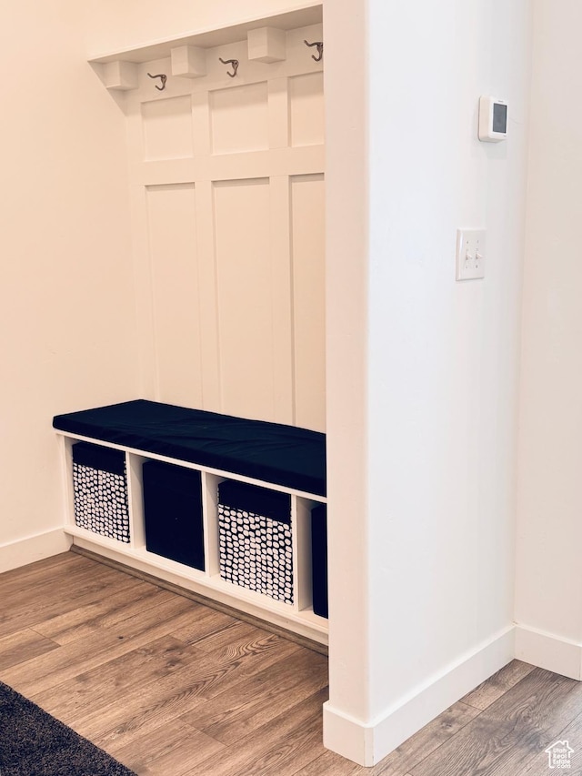 mudroom with baseboards and wood finished floors