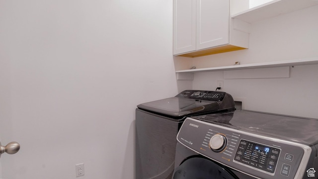 laundry area with washer and clothes dryer and cabinet space