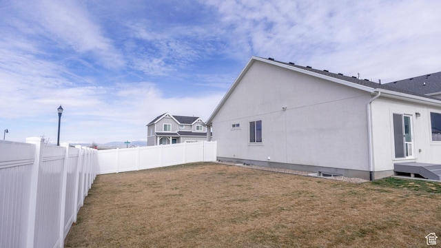 view of home's exterior featuring a yard and a fenced backyard