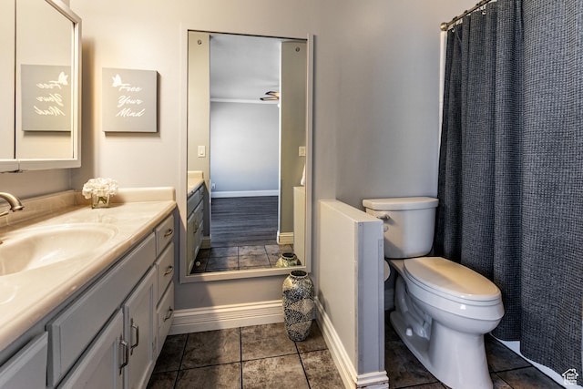 bathroom with tile patterned floors, vanity, toilet, and baseboards