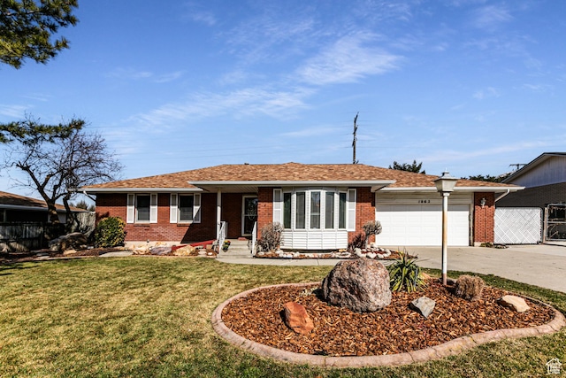 single story home with concrete driveway, an attached garage, fence, a front lawn, and brick siding