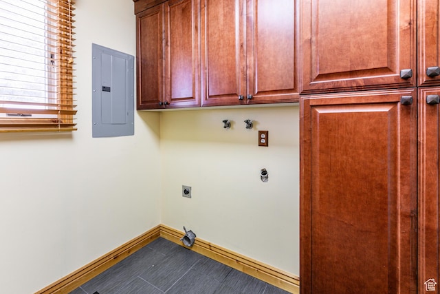clothes washing area featuring baseboards, cabinet space, electric panel, and hookup for an electric dryer