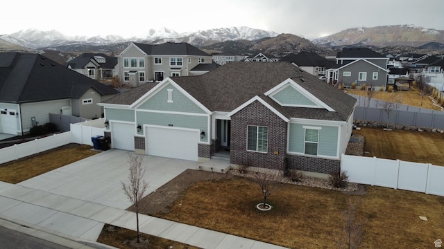 13592 S Conie Bell Dr, Herriman, UT 84096 - view of front of house featuring concrete driveway, an attached garage, a mountain view, fence private yard, and a residential view