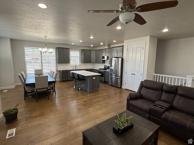 13592 S Conie Bell Dr, Herriman, UT 84096 - living area with recessed lighting, visible vents, a textured ceiling, wood finished floors, and baseboards