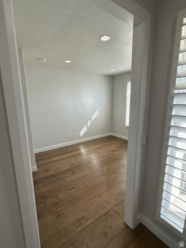 13592 S Conie Bell Dr, Herriman, UT 84096 - empty room featuring dark wood-style floors, baseboards, a textured ceiling, and recessed lighting