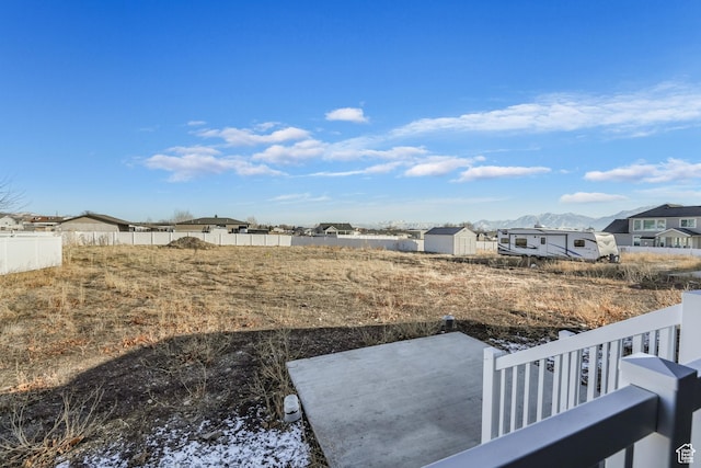 view of yard featuring a patio area, a residential view, and fence