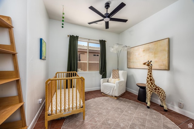 340 N Snow Canyon Dr Unit 4, Ivins, UT 84738 - bedroom with a nursery area, tile patterned flooring, baseboards, and ceiling fan