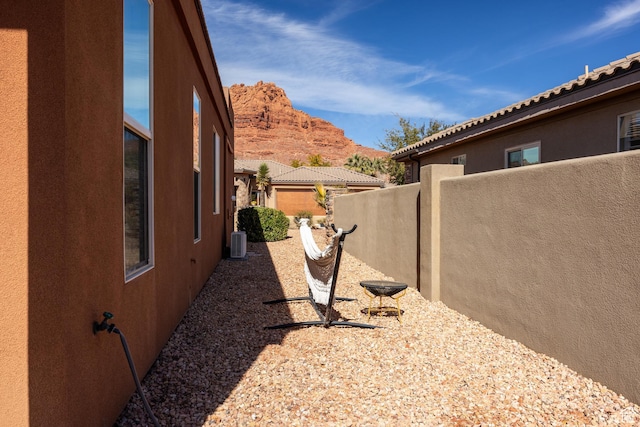 340 N Snow Canyon Dr Unit 4, Ivins, UT 84738 - view of yard with a mountain view, fence, and central air condition unit