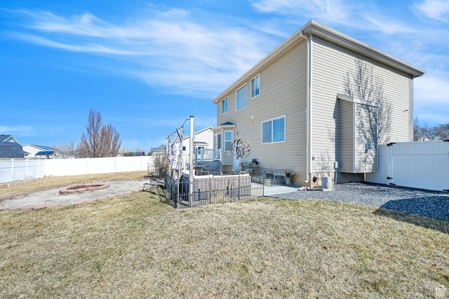 1087 N 1000 W, Clinton, UT 84015 - back of house with a yard, a fenced backyard, a fire pit, and a patio