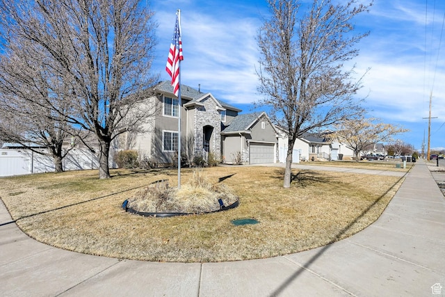 1087 N 1000 W, Clinton, UT 84015 - view of front of house featuring stone siding, stucco siding, an attached garage, fence, and a front yard